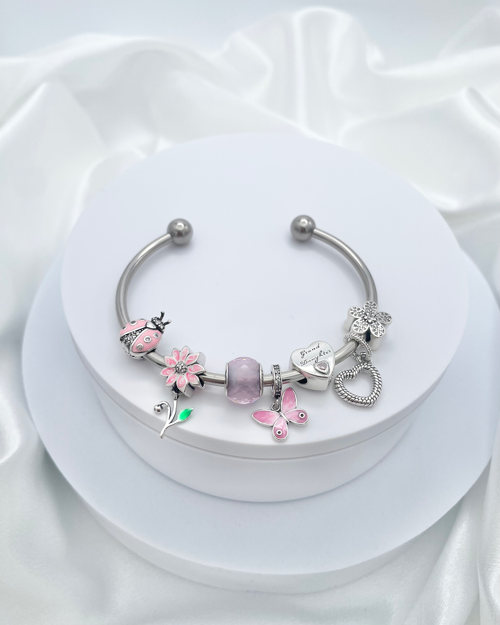 Thumbnail: Linx Stainless Steel Open Bangle with Granddaughter Themed Charms 