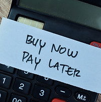 Concept of Buy Now Pay Later write on sticky notes isolated on Wooden Table.jpg