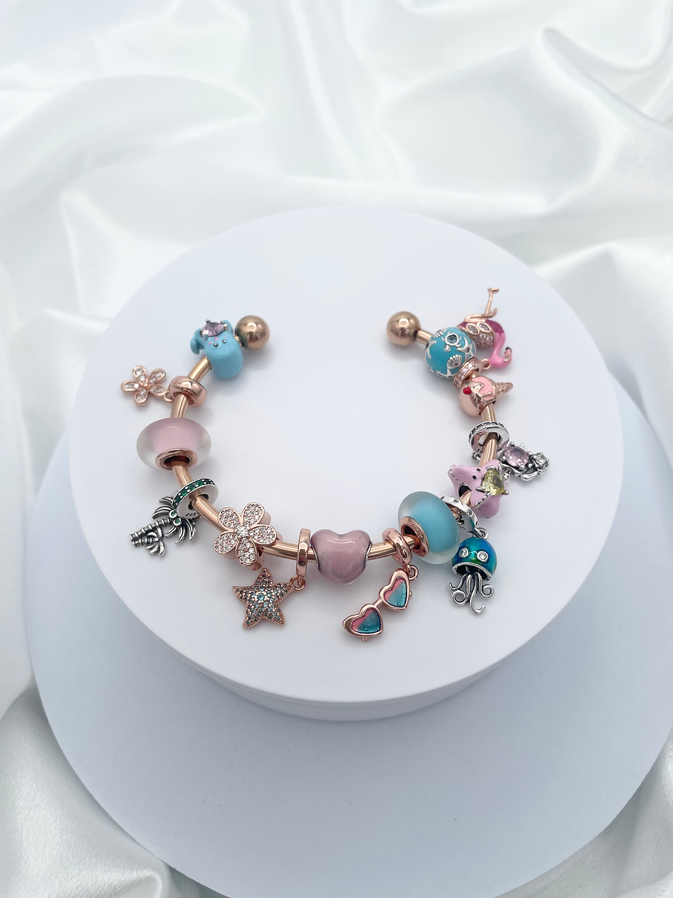 Thumbnail: Linx Rose Gold Open Bangle with Pink and Blue Beach Themed Charms 