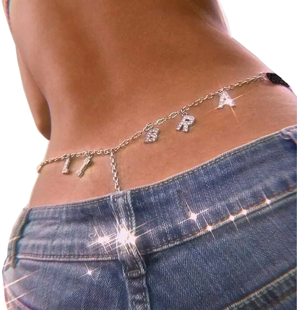 Back view of a model wearing Libra rhinestone zodiac thong, glowing in glam with luxe sparkle and divine feminine flair