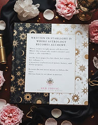 Back cover of the Her Zodiac Written in Starlight personalized astrology book surrounded by pink roses and crystals