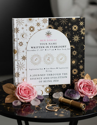 Her Zodiac Written in Starlight personalized birth chart book displayed upright with pink roses, amethyst, and rose quartz