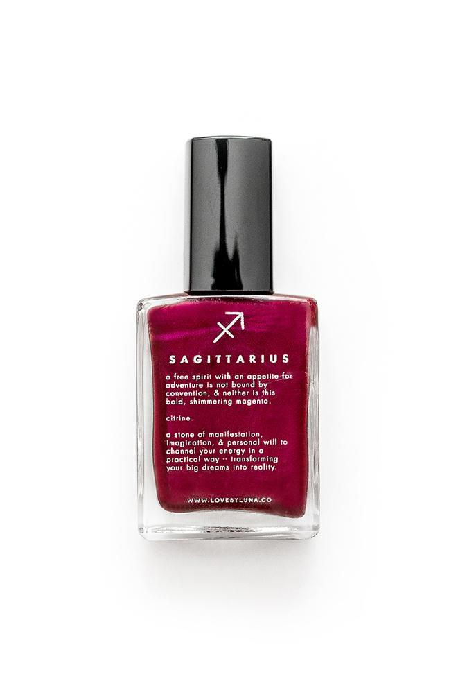Front-facing Sagittarius nail polish bottle in metallic magenta with sleek label and Citrine crystal shimmer