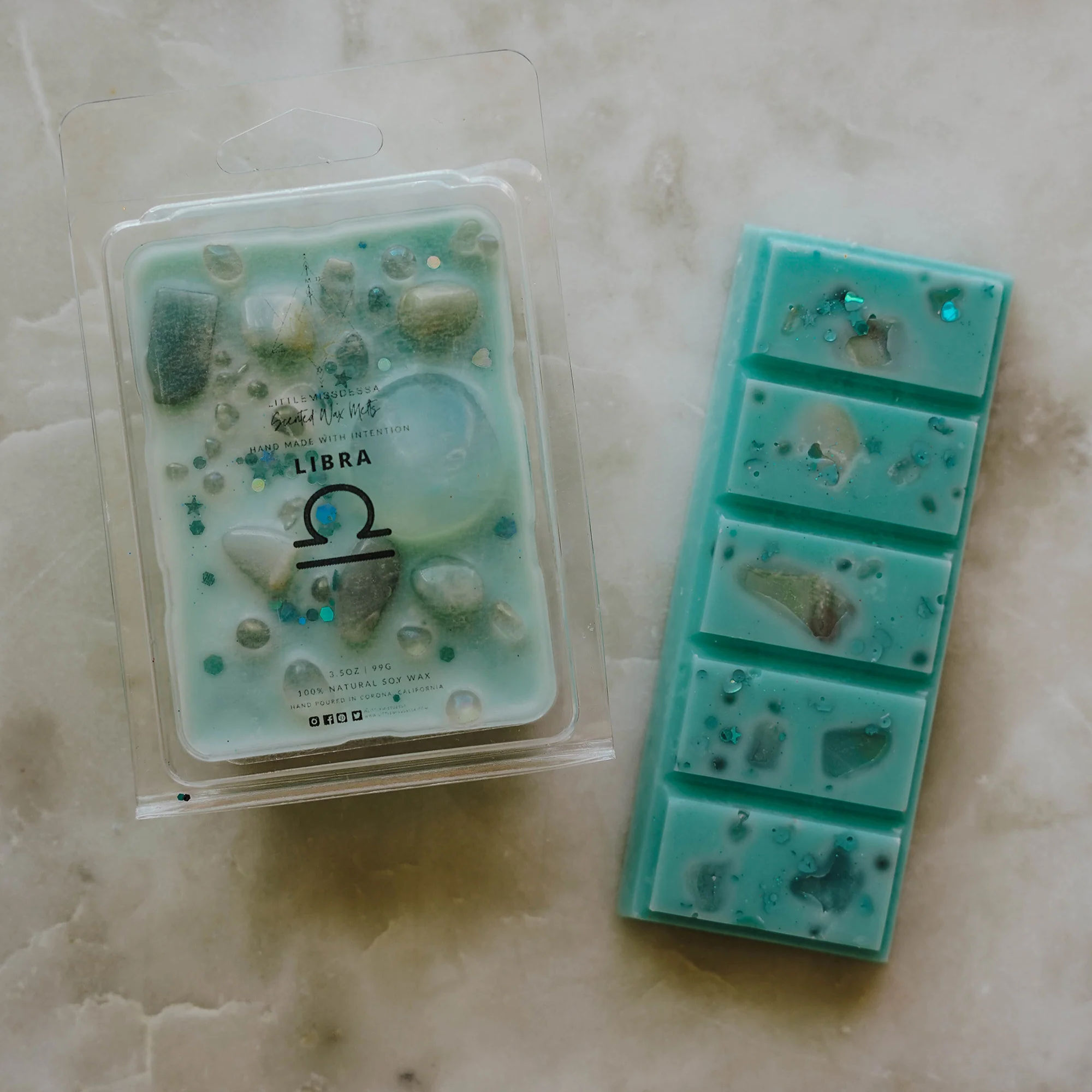 Libra zodiac wax melt and snap bar in soft blue tones with crystals, displayed on cream marble background