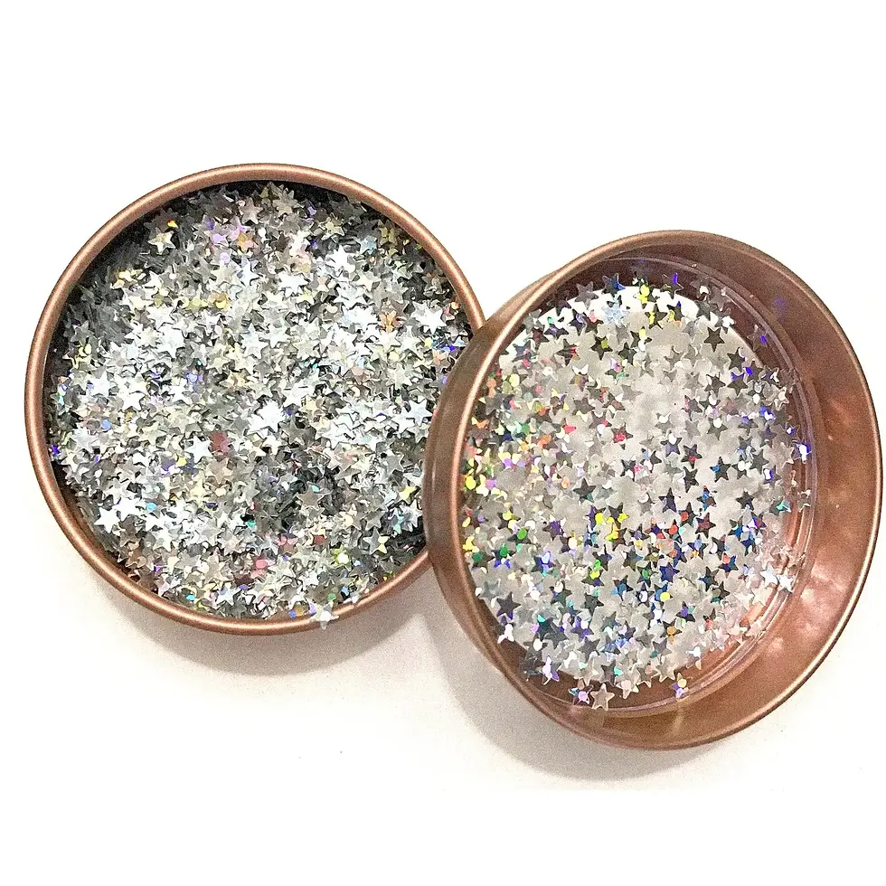 op-down view of Halo glitter jar with lid off, revealing iridescent star-shaped glitter pieces