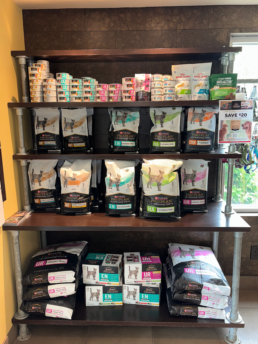 Shelves stocked with pet pharmacy & food supplies.
