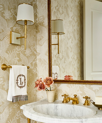 Atlanta luxury condo powder room with bird wallpaper, marble console sink and brass fixtures.