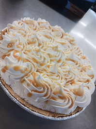 close up of whipping cream on a caramel pie 