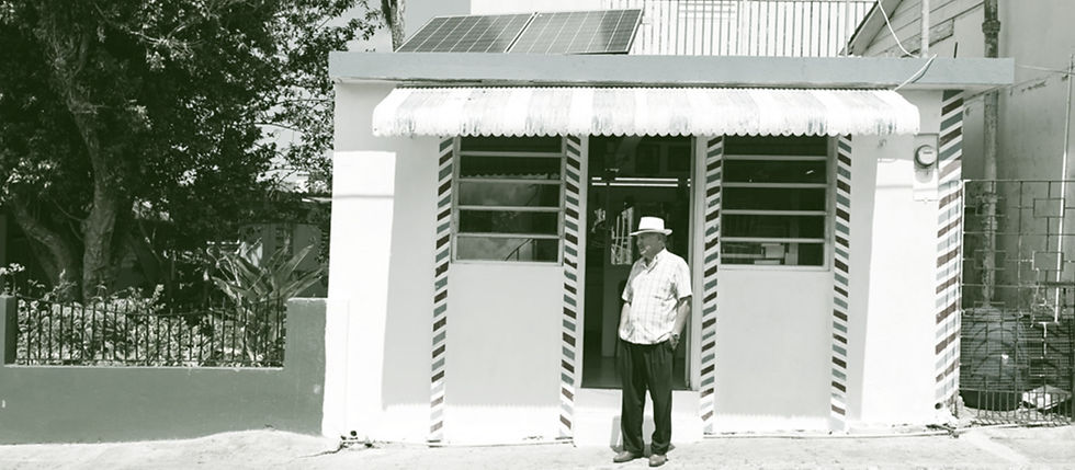 A man stands in front of his store, with a new installation from Marvel Designs. Image Credit: Marvel Designs