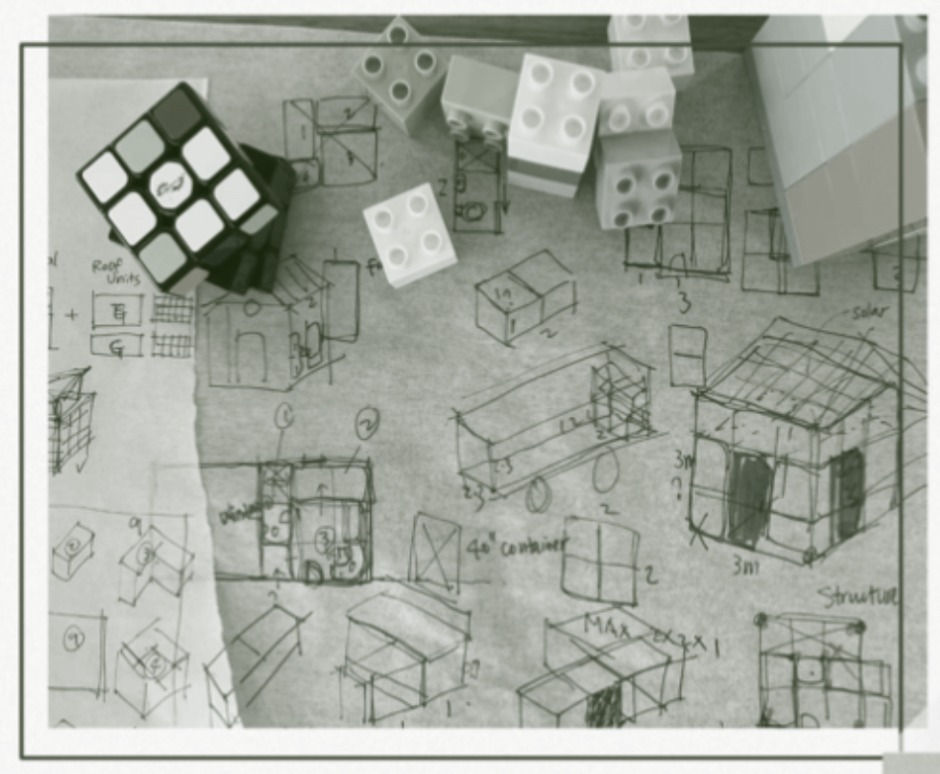 Sketches of Renee Wang's tiny homes lie underneath her inspiration: a Rubik's Cube and Lego pieces. Image Credit: Renee Wang