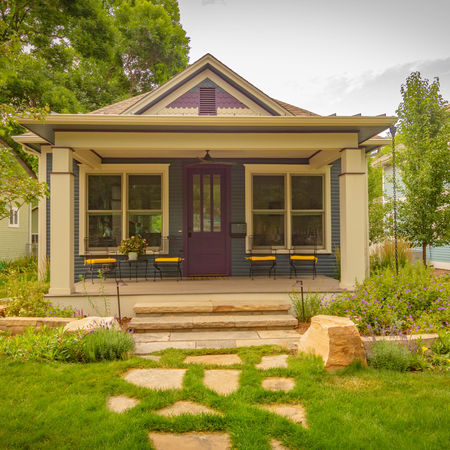 Renovated Old Town Fort Collins Craftsman bungalow featuring refinished wood siding, tapered porch columns, new shingle roof, restored original windows, and refreshed native landscaping that maintains the home’s historic character.
