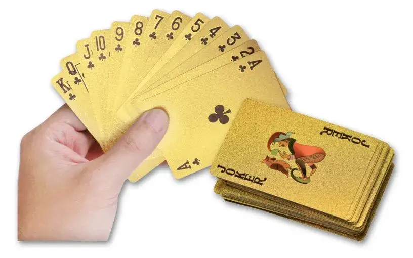 hand fanning out 24 karat gold poker cards