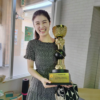 「I Love Bharat」で第2回アジアヨガアーサナスポーツチャンピオンシップ大会で「準優勝」トロフィーと一緒に誇らしげにポーズをとる女性