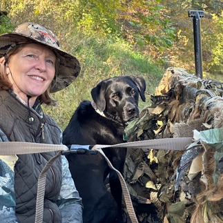 woman and her tallgrass kennels lab in hunting blind