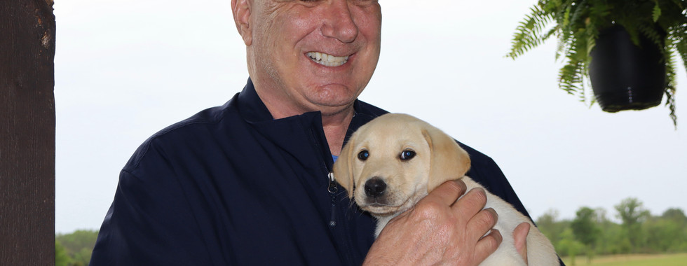 happy tallgrass british lab kennel customer with yellow lab puppy