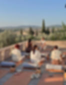A group connecting outdoors on a sunlit rooftop terrace