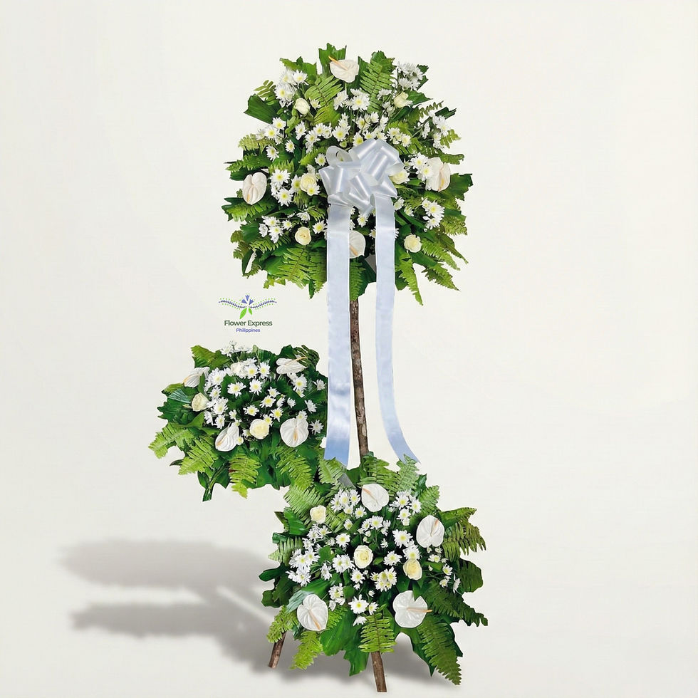Three layered white funeral flower stand featuring anthuriums, roses, and mums with lush greenery and a white ribbon by Flowe