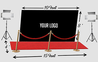 A black step and repeat backdrop measuring 10 feet wide and 8 feet tall, with placeholder text "YOUR LOGO" in the center, suggesting space for branding or event sponsors. A red carpet that is 15 feet long and 4 feet wide. Gold stanchions with red velvet ropes, creating a VIP entrance effect. Two professional studio lights on tripods, positioned on either side of the backdrop for optimal lighting.
