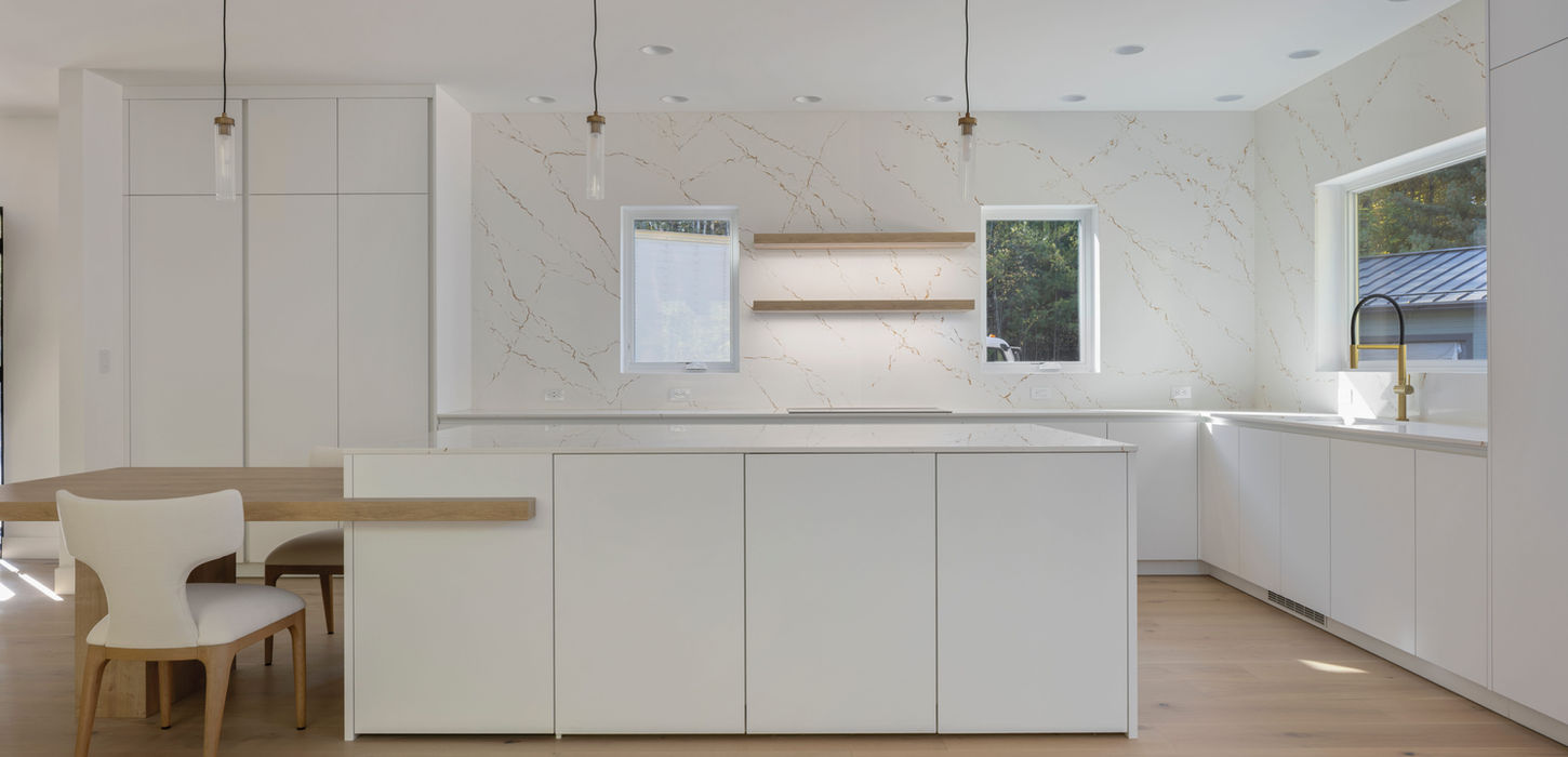 Stark modern white kitchen with warm wooden accents.