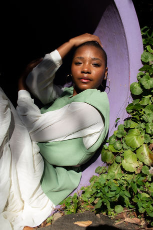 Woman in Green Vest, Walking Outdoors