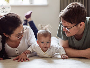 Baby and parents in tummy time position benefiting their health and wellness