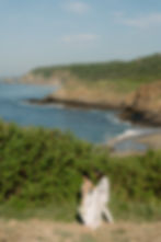 Bride and groom walking barefeet in Punta Cometa with ocean view