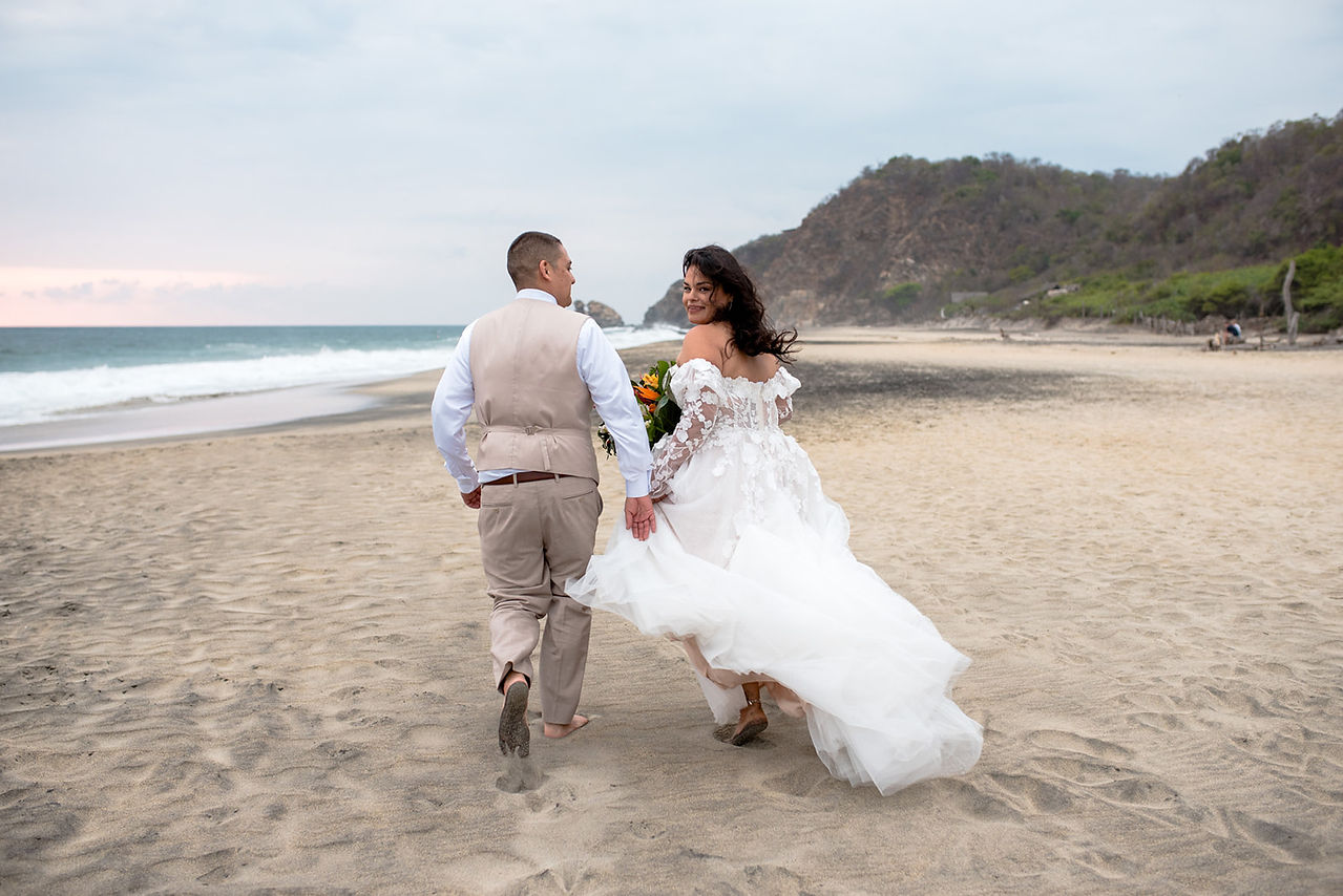Bride and groom posing on the beach during their destination wedding in Mazunte Oaxaca