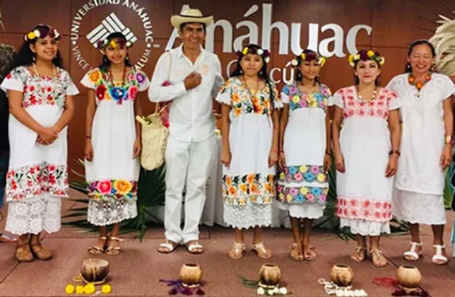 Group in traditional embroidered dress at Anáhuac University, Cancún
