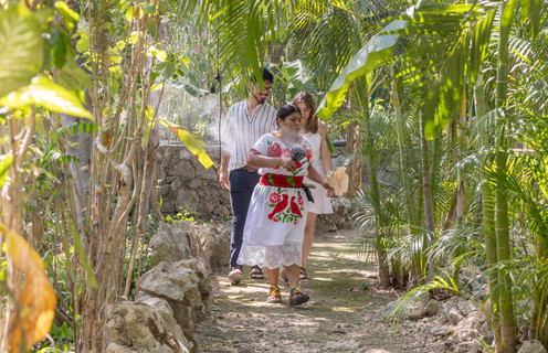Spiritual guide walking through the jungle to begin a sacred wedding ceremony in Playa del Carmen