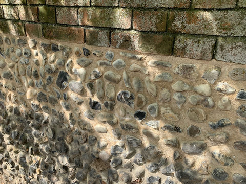 Repointing a section of flint wall - South Norfolk.