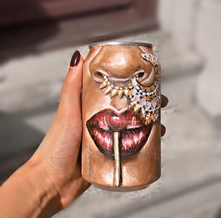 Close-up of face with nose ring and straw painted on a can