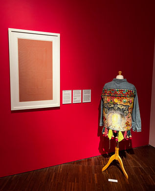 Collaged and painted Denim jacket displayed in art gallery