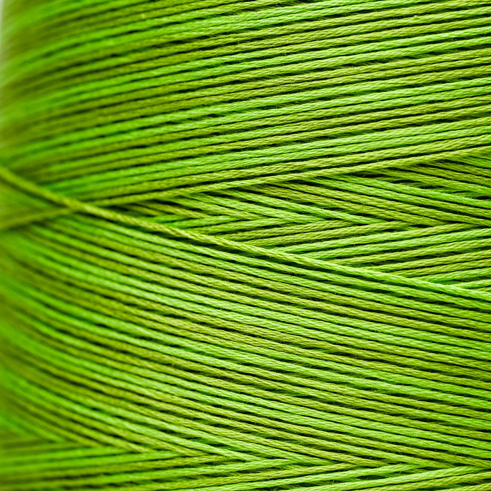 Close-up of vibrant green thread wound on a spool, Bloomfield Craft