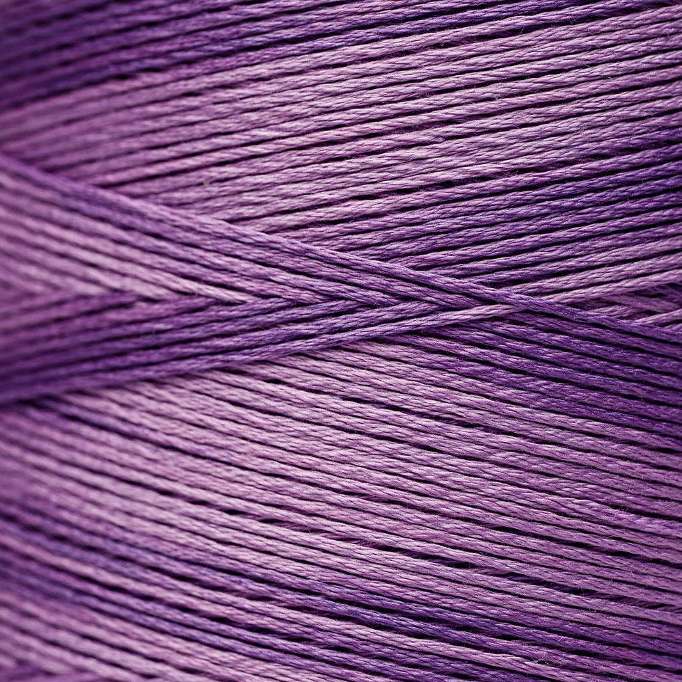 Close up of purple yarn, with various shades for crafting projects.