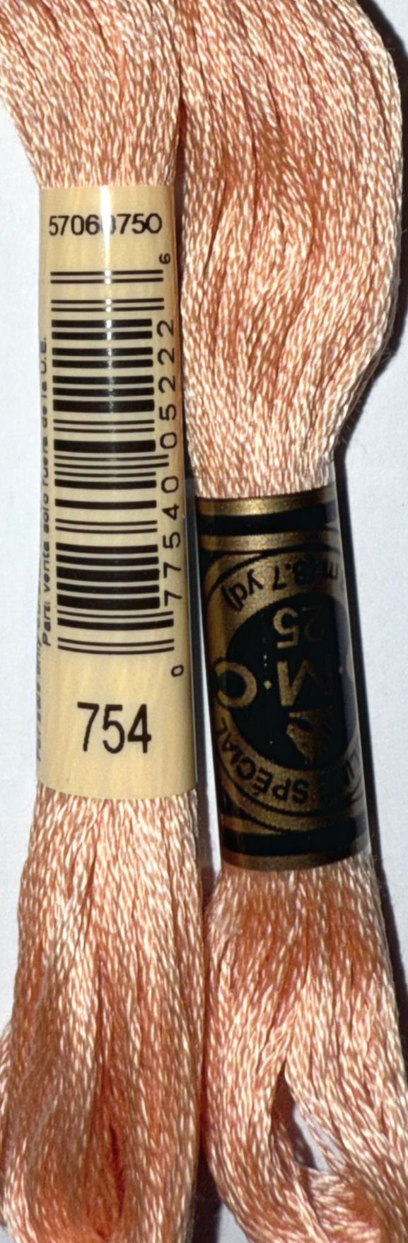 DMC Floss Color 754 near another DMC Floss, background detail, Bloomfield Craft.