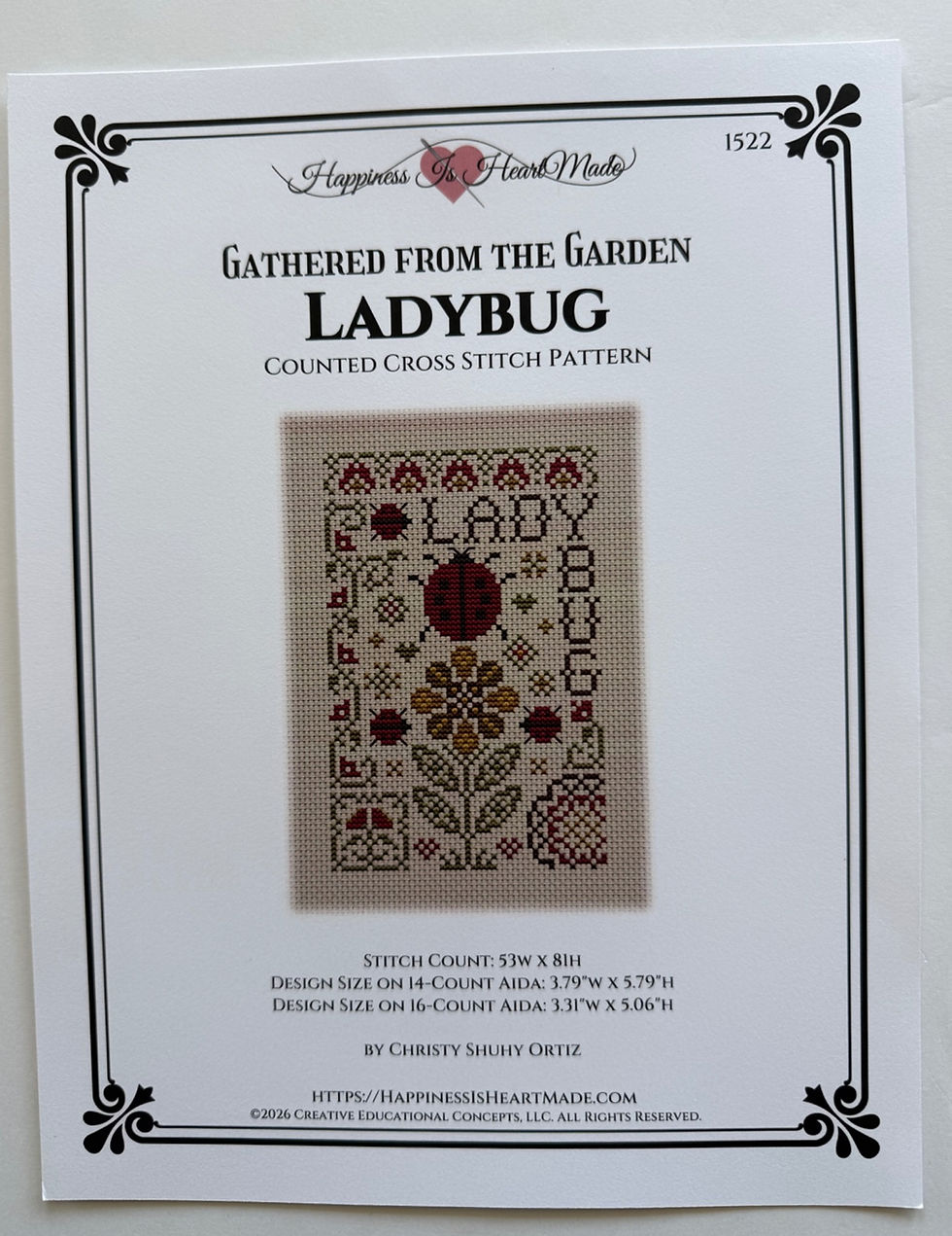 Gathered from the Garden Ladybug counted cross stitch pattern cover by Happiness Is HeartMade.