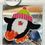 Thumbnail: Cute cross-stitched penguin with bright hat and orange feet from the Penguin Holiday Series.