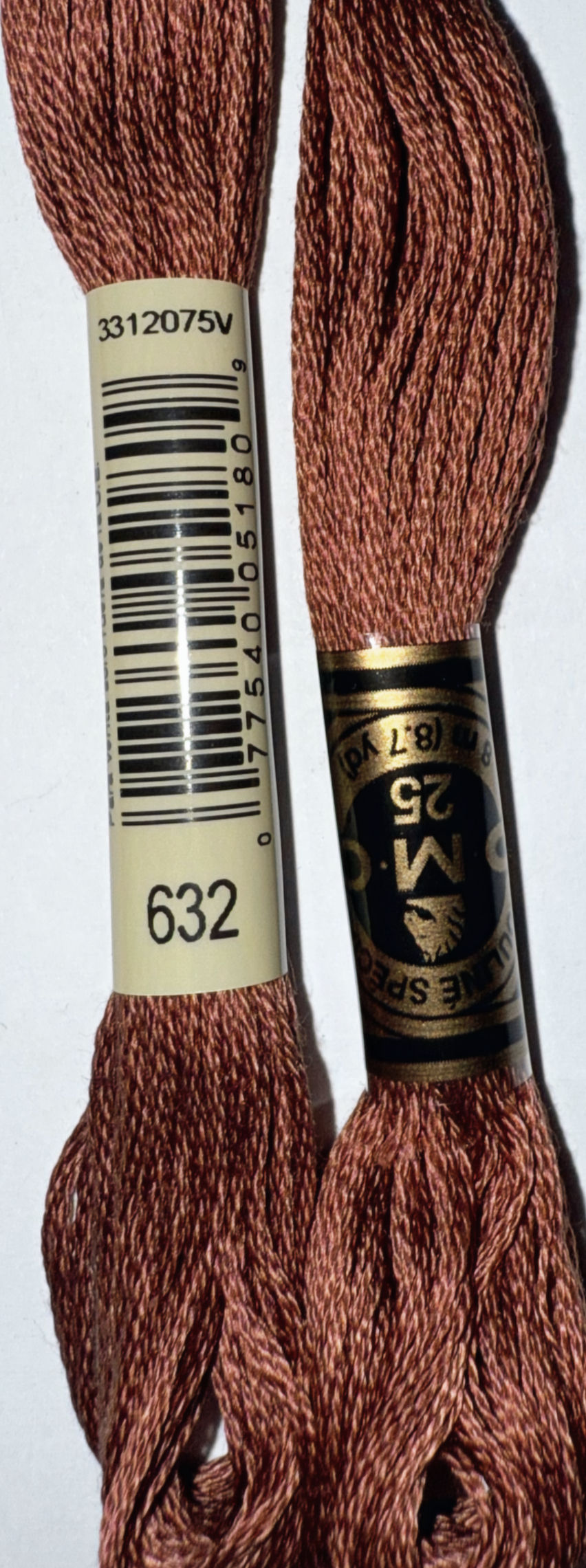 Two spools of DMC floss color 632 in a close-up shot Bloomfield Craft