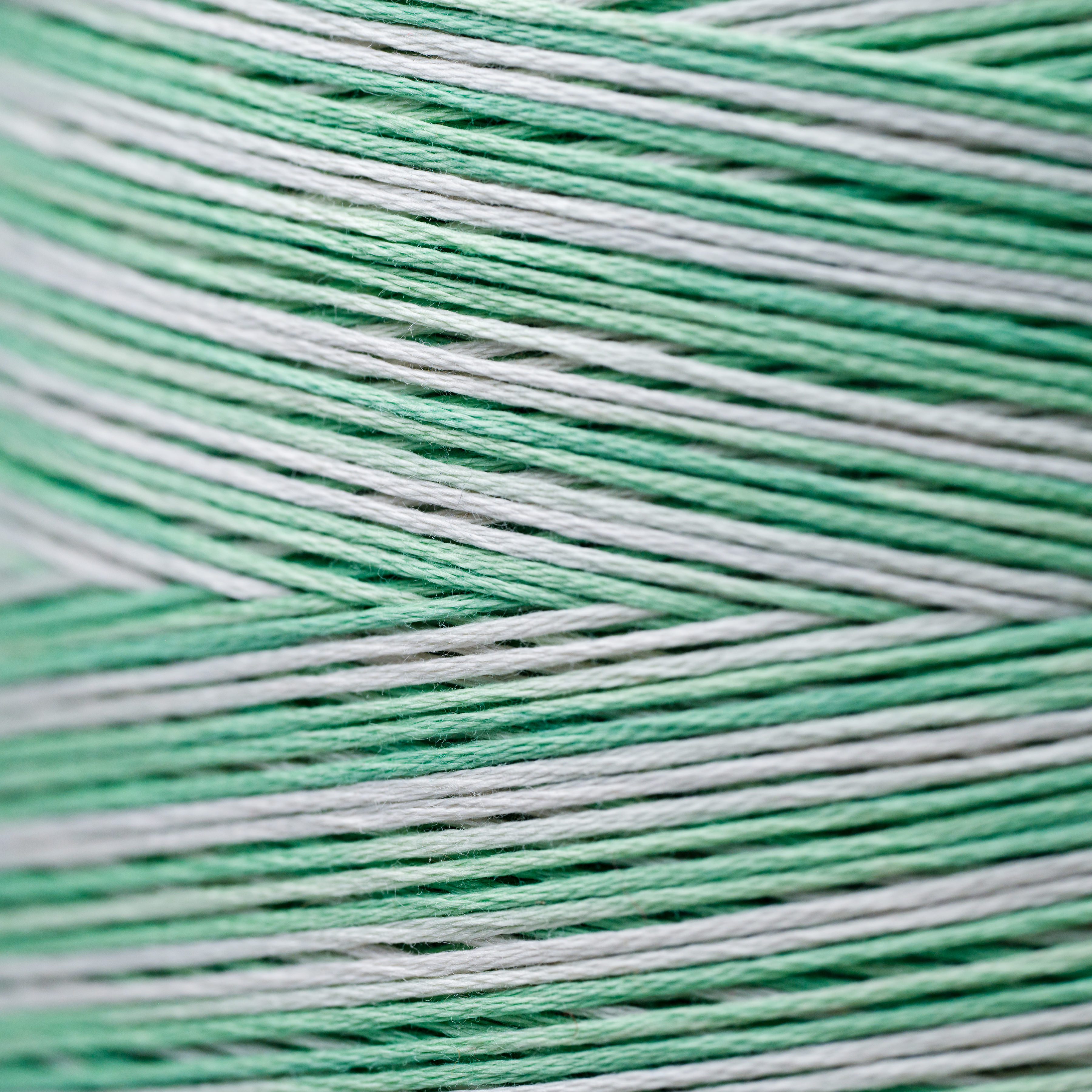 Close-up of green and white yarn wound on a spool, Bloomfield Craft.