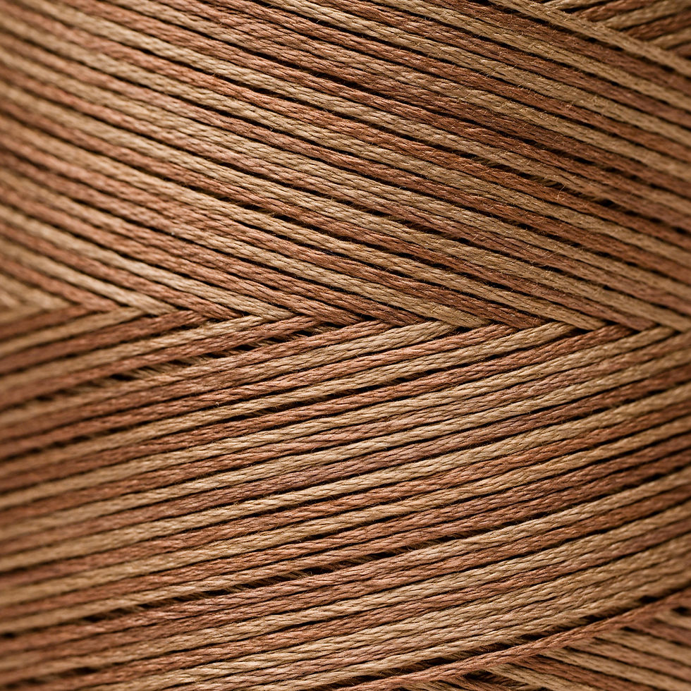 Close-up of brown thread spool, intricate texture, for crafting and sewing.