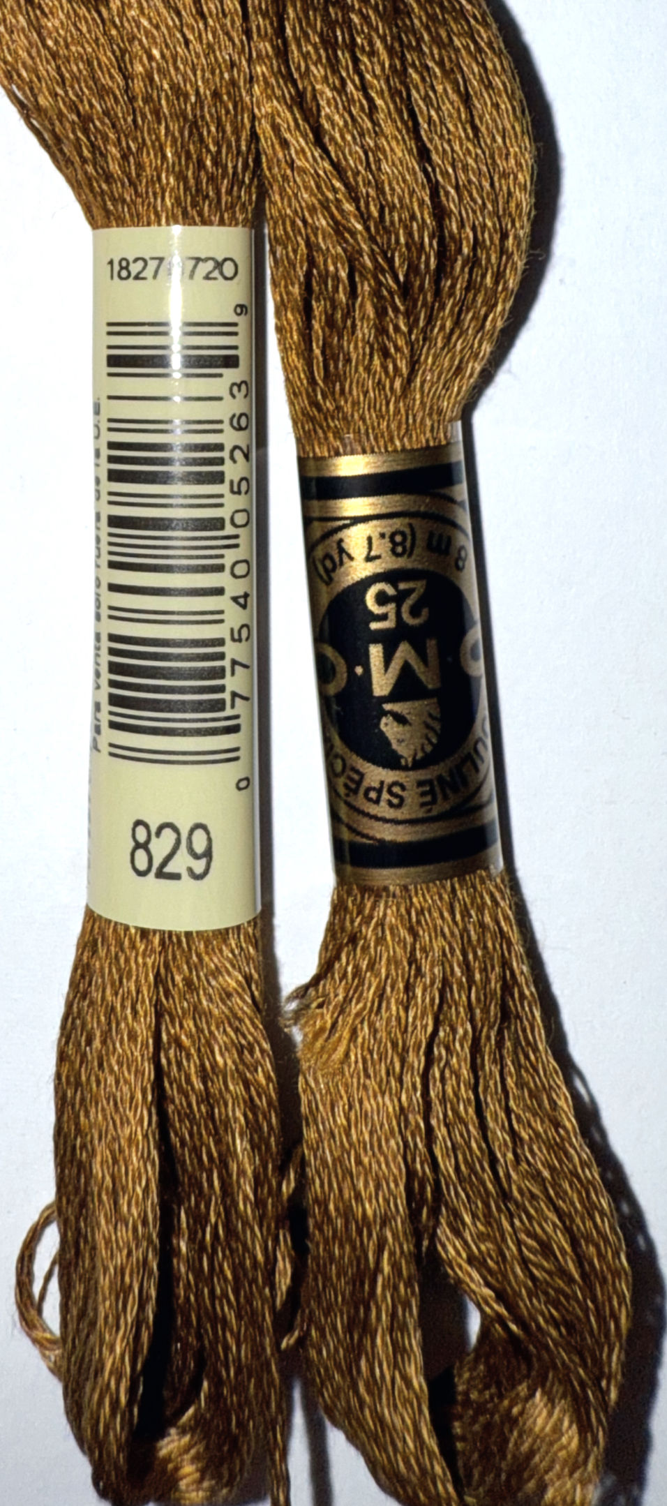 Two spools of DMC embroidery floss with 829 label. Bloomfield Craft.
