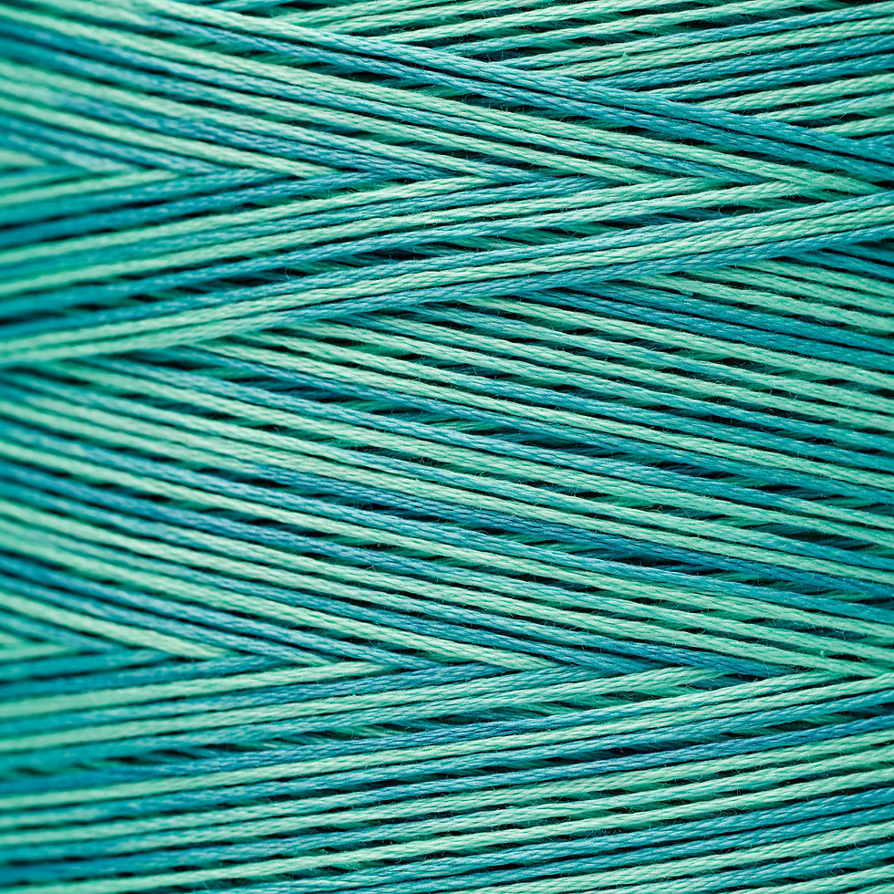Close-up of a spool of teal thread, intricate weaving pattern detail, Bloomfield Craft.
