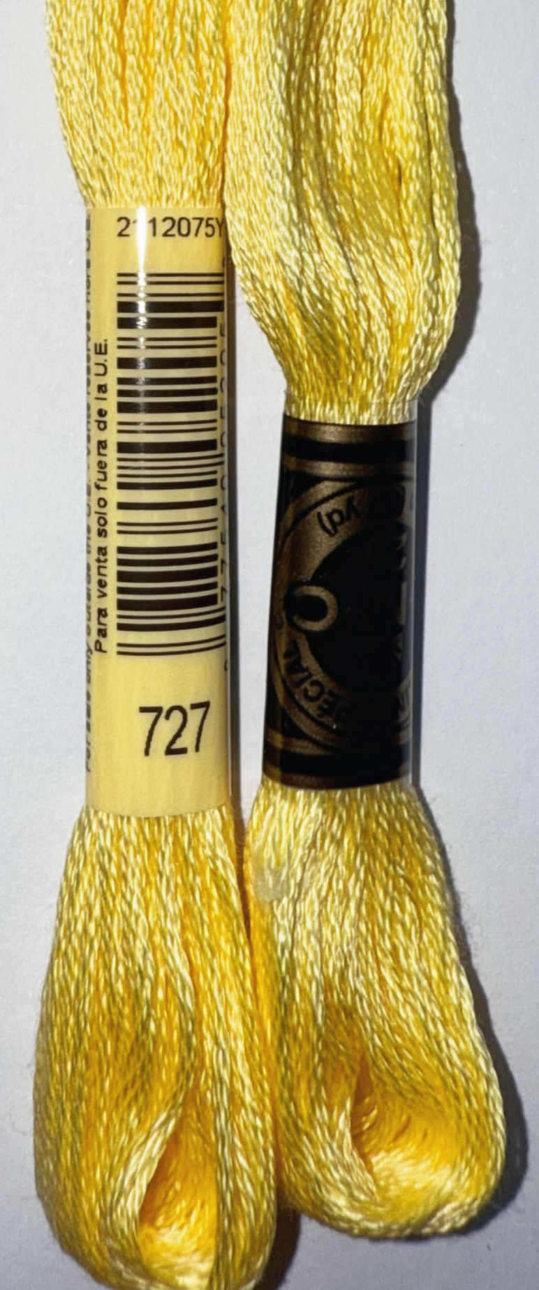 DMC Floss Color 727, yellow thread spools with barcode and text for sale.