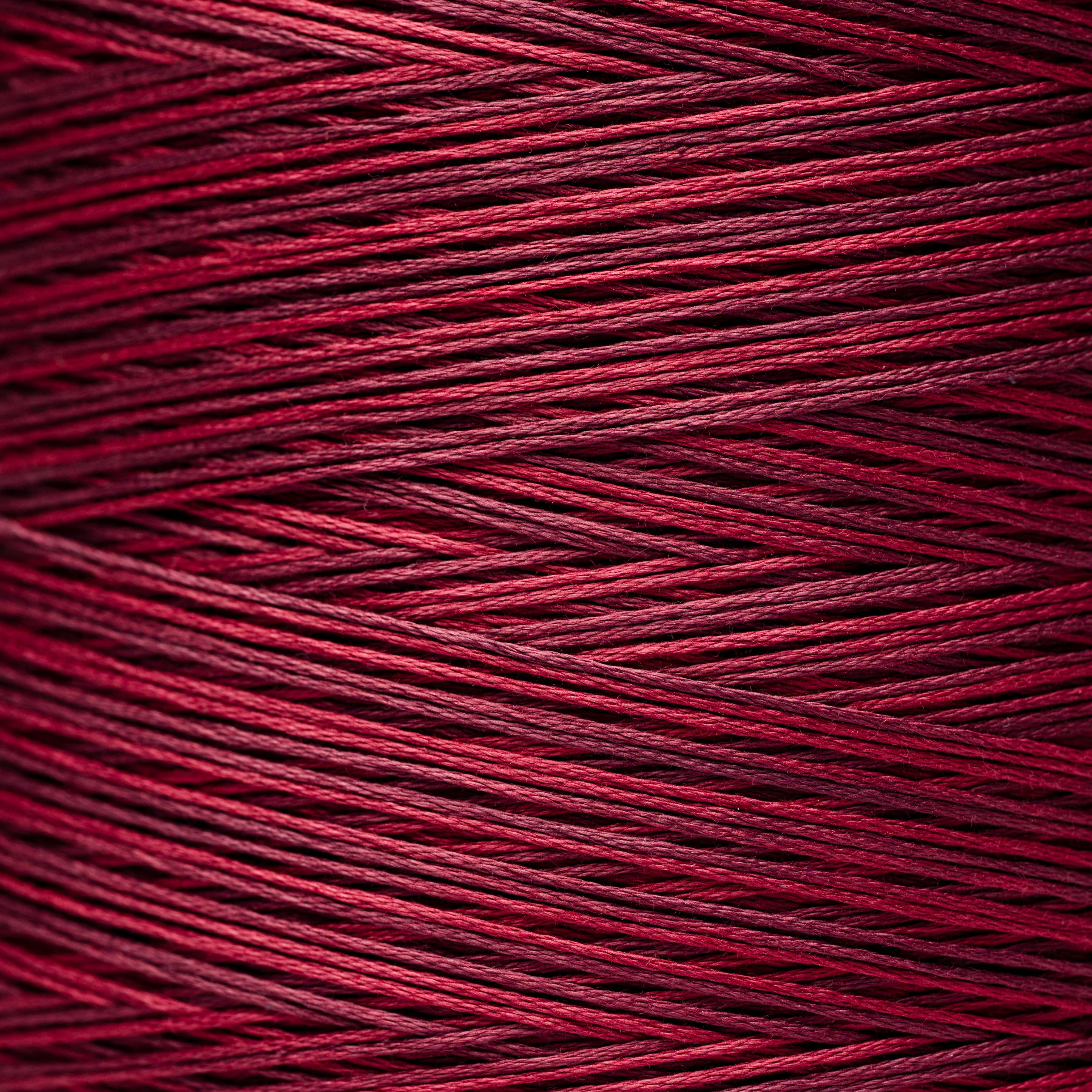 Close-up of red thread spool, showing tightly wound threads, Bloomfield Craft.