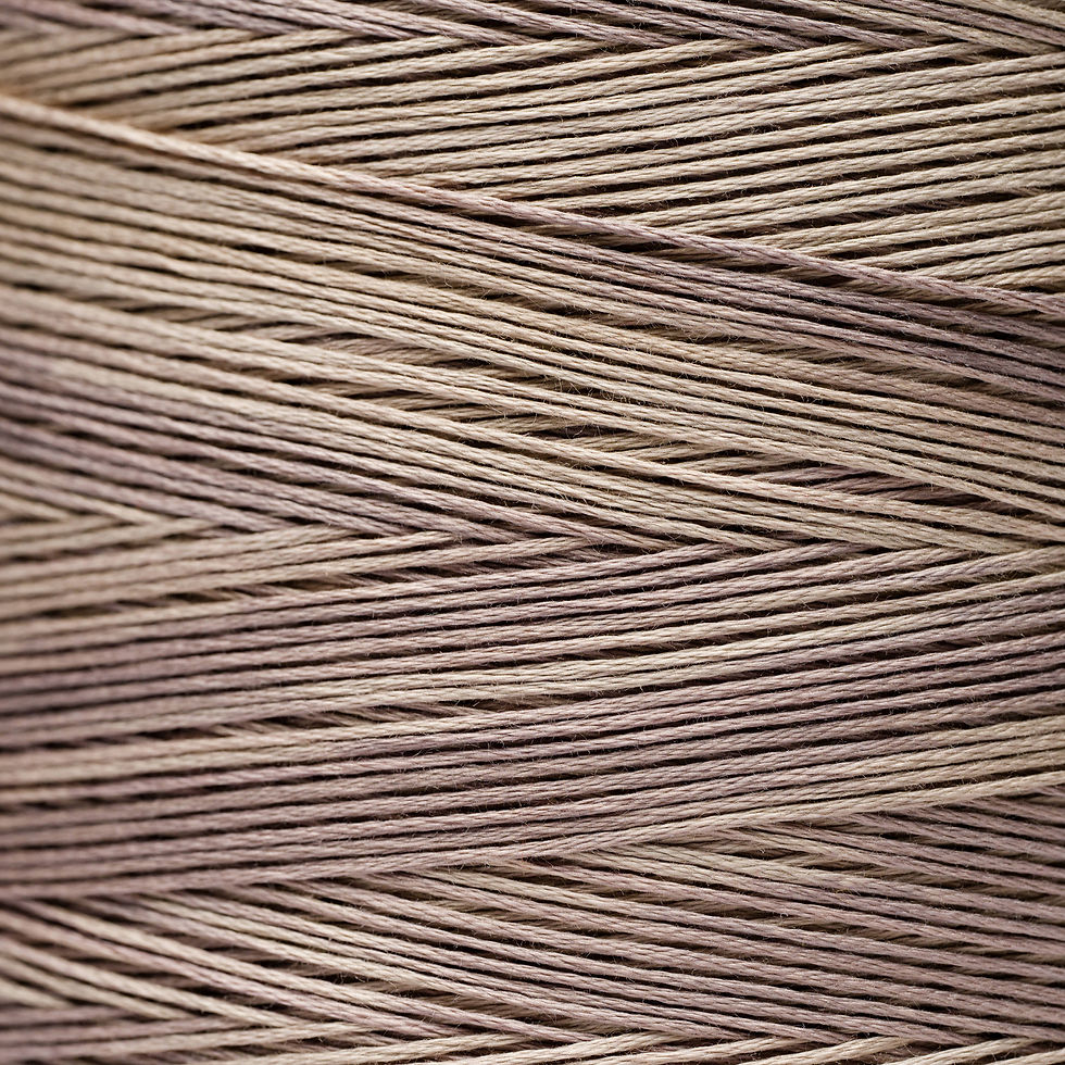 Close-up of beige thread wound tightly, creating a textured pattern.