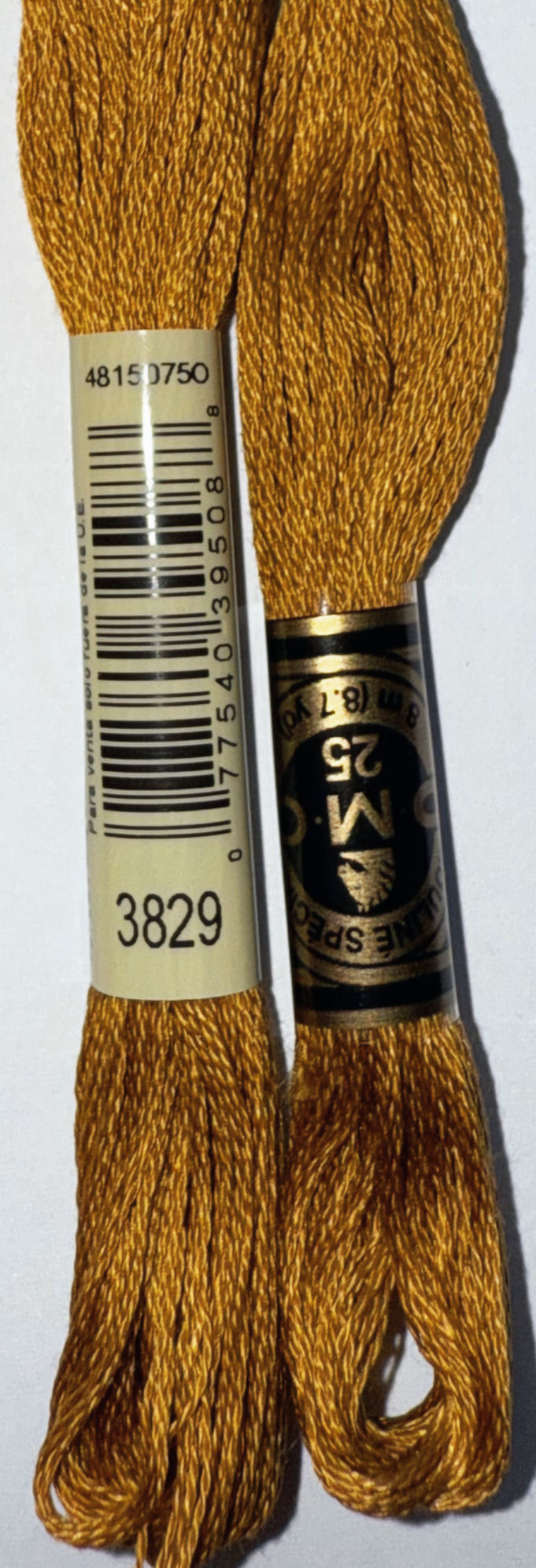 Two spools of DMC 3829 embroidery floss with visible text and details.