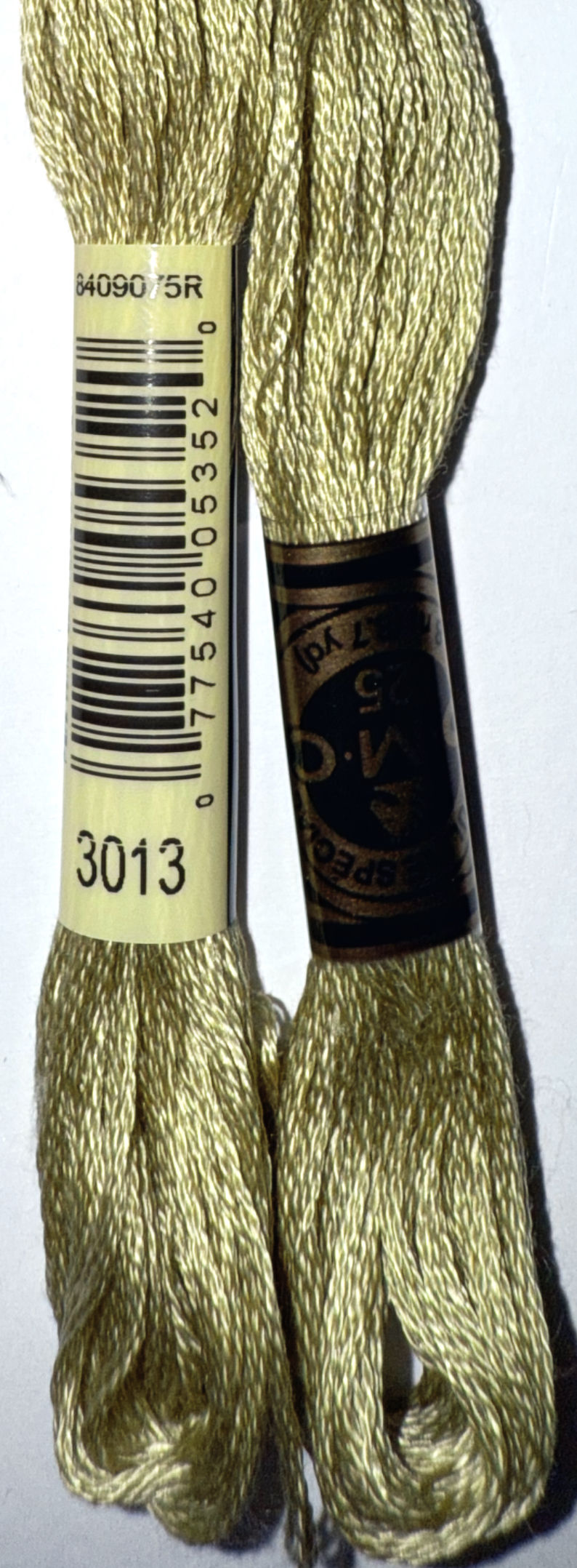 DMC Embroidery Floss 3013 with label and barcode on white surface. Bloomfield Craft