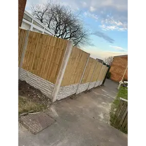 A bespoke fence which includes a concrete base 