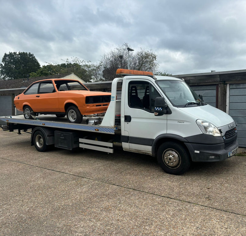 A picture showing an orange car collected for selling 