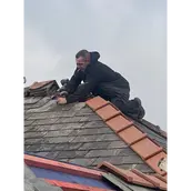 A slate roof being repaired
